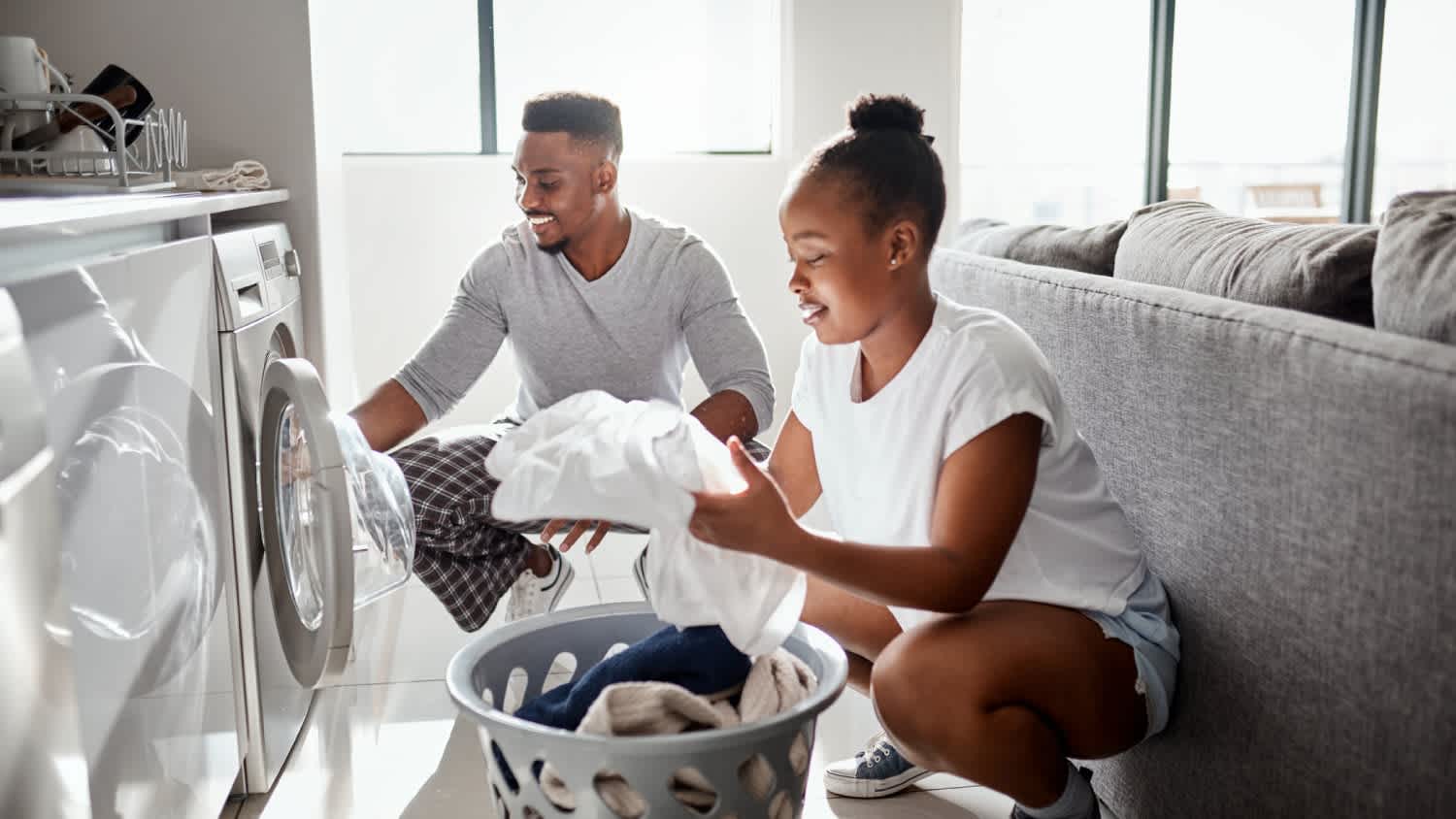 A couple doing laundry together at home