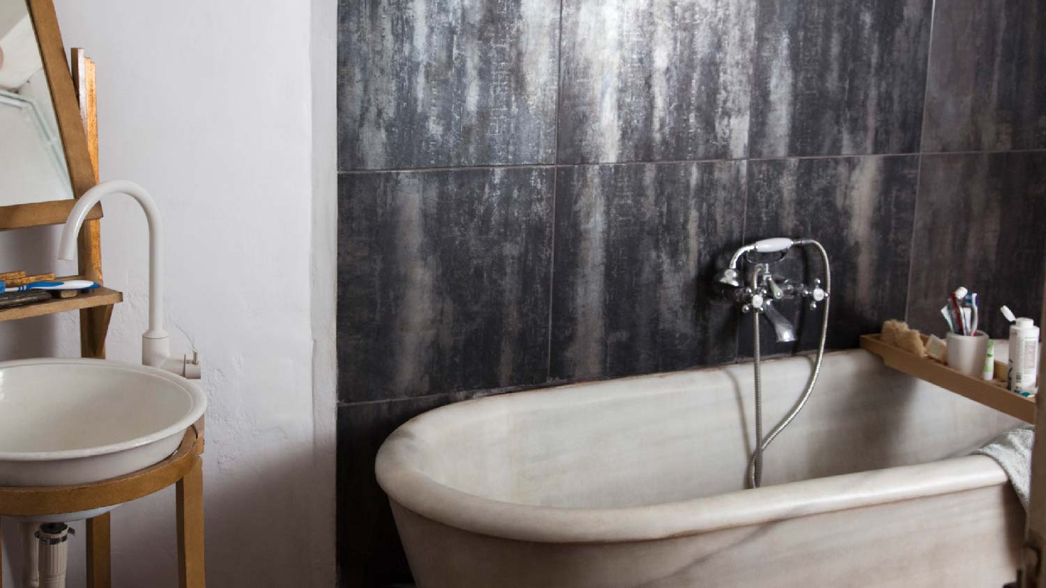 An atmospheric bathroom with a marble tub