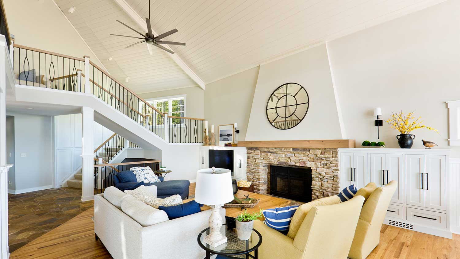 High ceiling living room with fireplace and ceiling fan