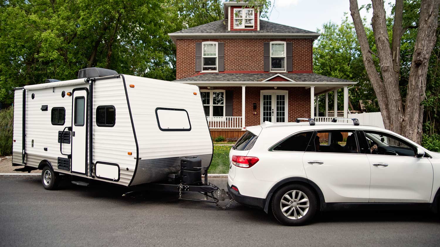 Family getting ready to leave with RV for summer vacations