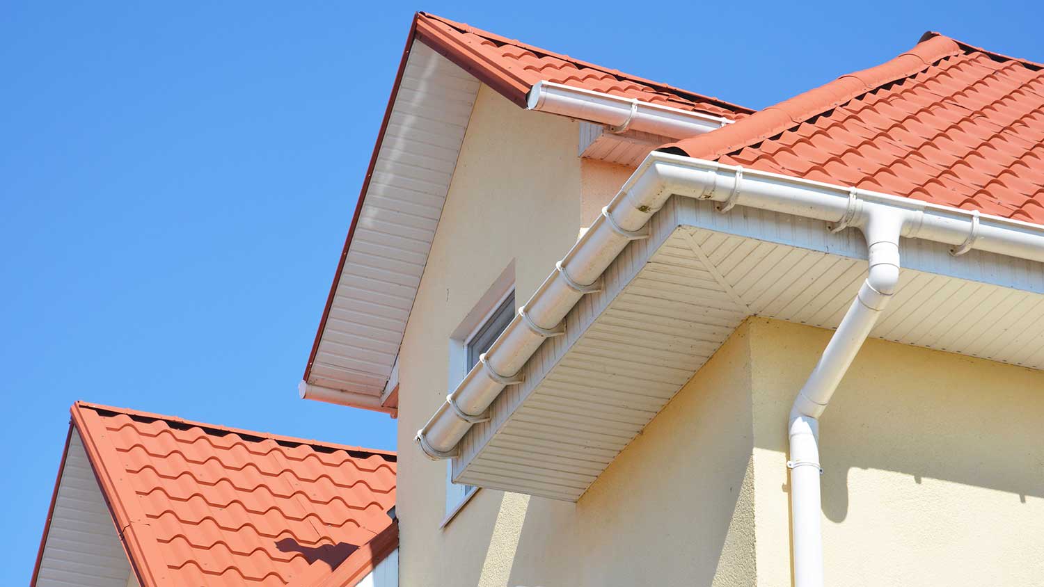 PVC gutter system installed on the roof of a house