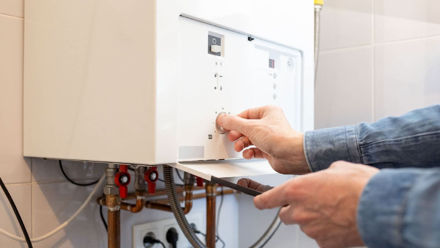 A man operating a gas water heater