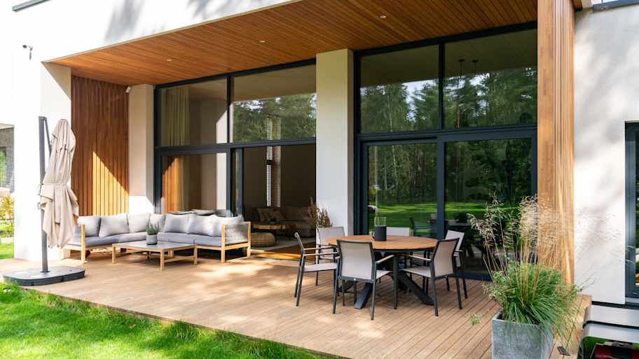 Contemporary house with wooden deck and wood siding