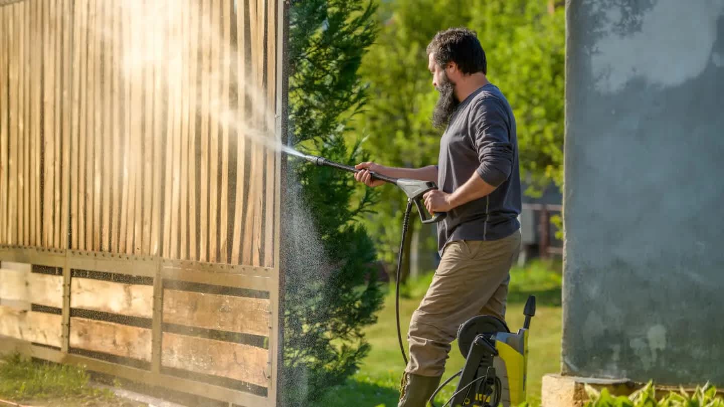 A man cleaning with a high water pressure cleaner