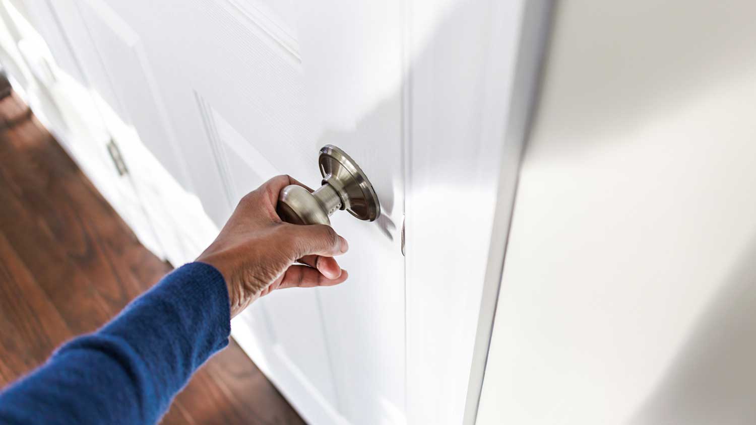 Person holding an interior doorknob
