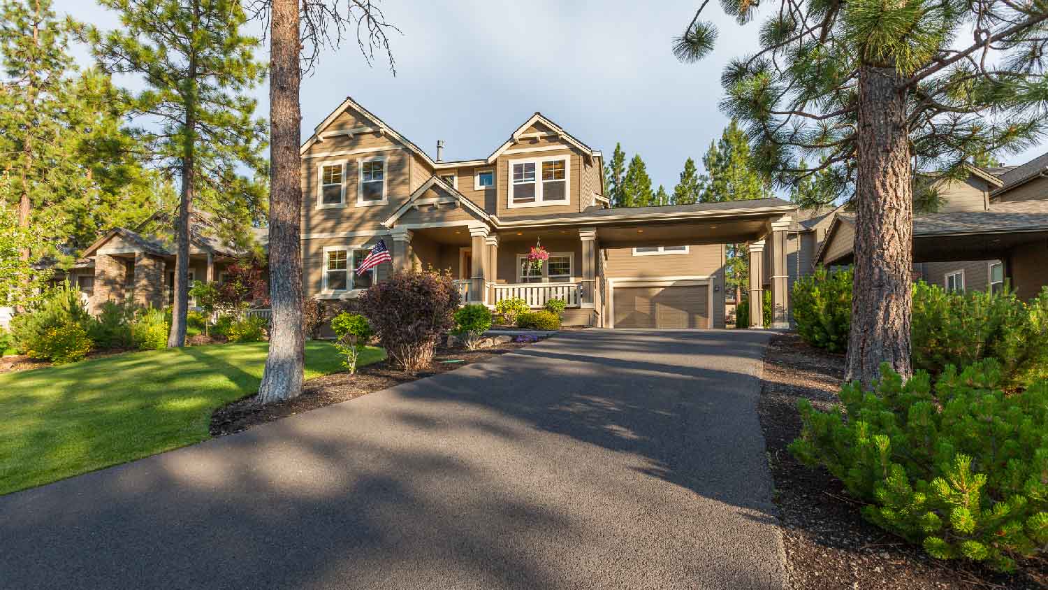 brick home with asphalt driveway