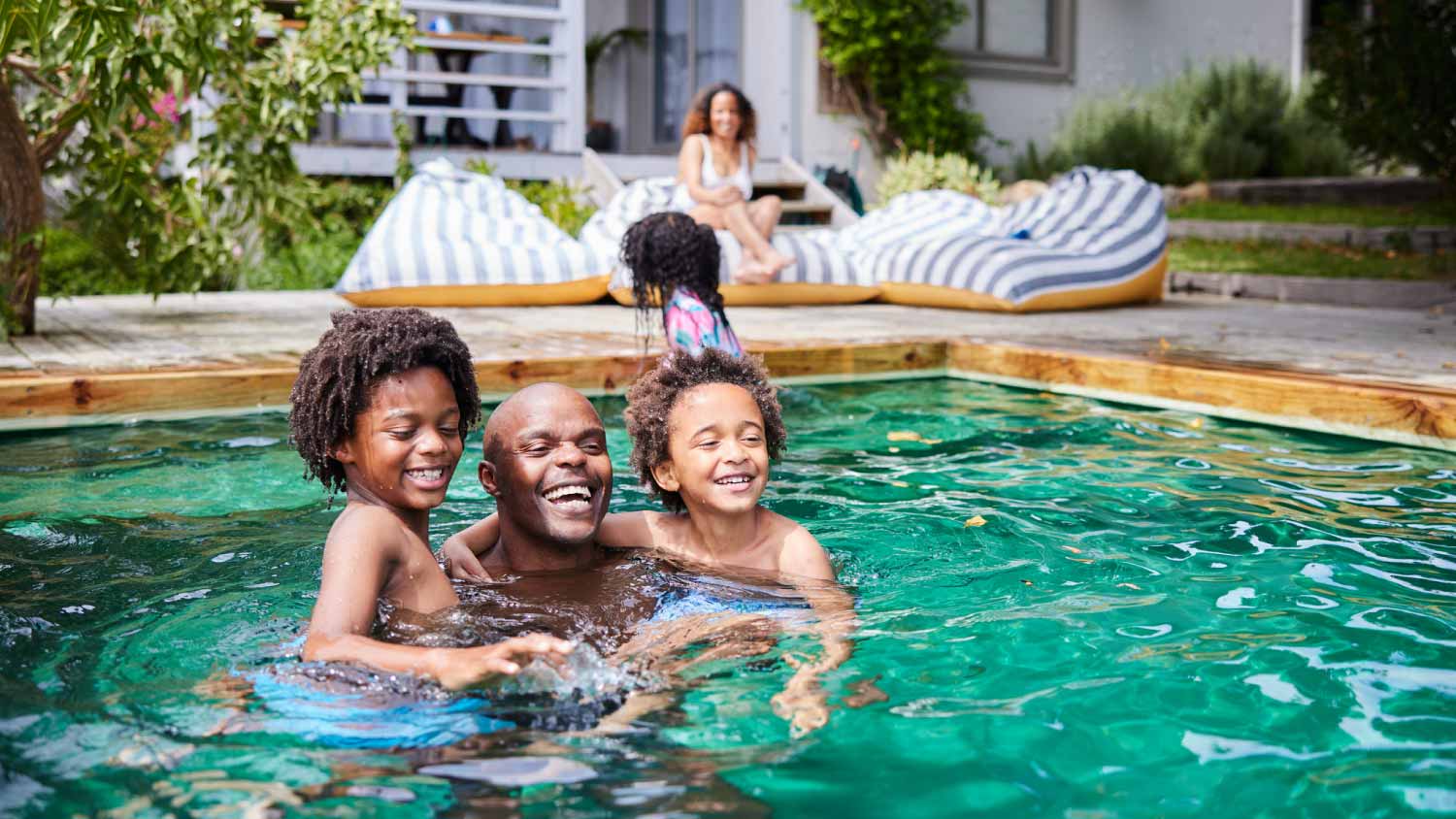 Dad playing with his kids in the pool
