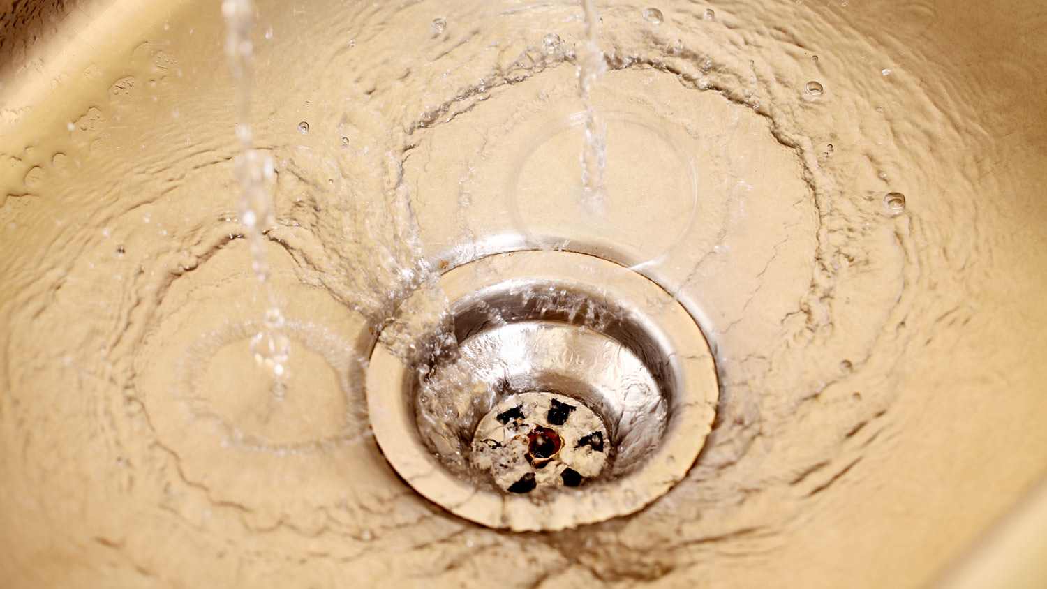 Close up of stainless steel sink plug hole