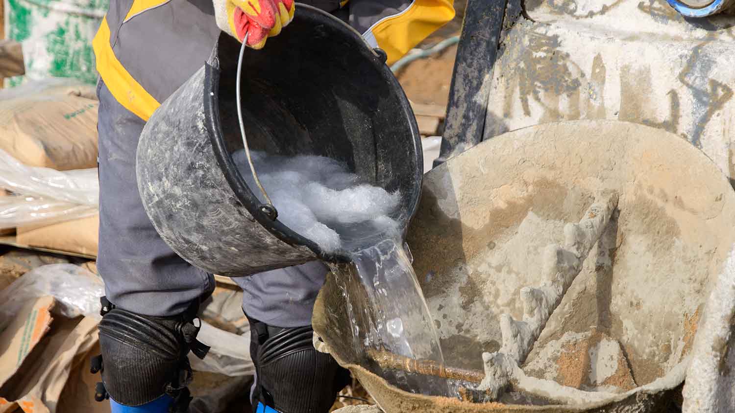 Worker adding carbon fiber into a concrete mixer