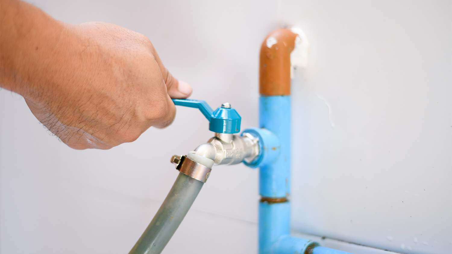 Hand on faucet valve.