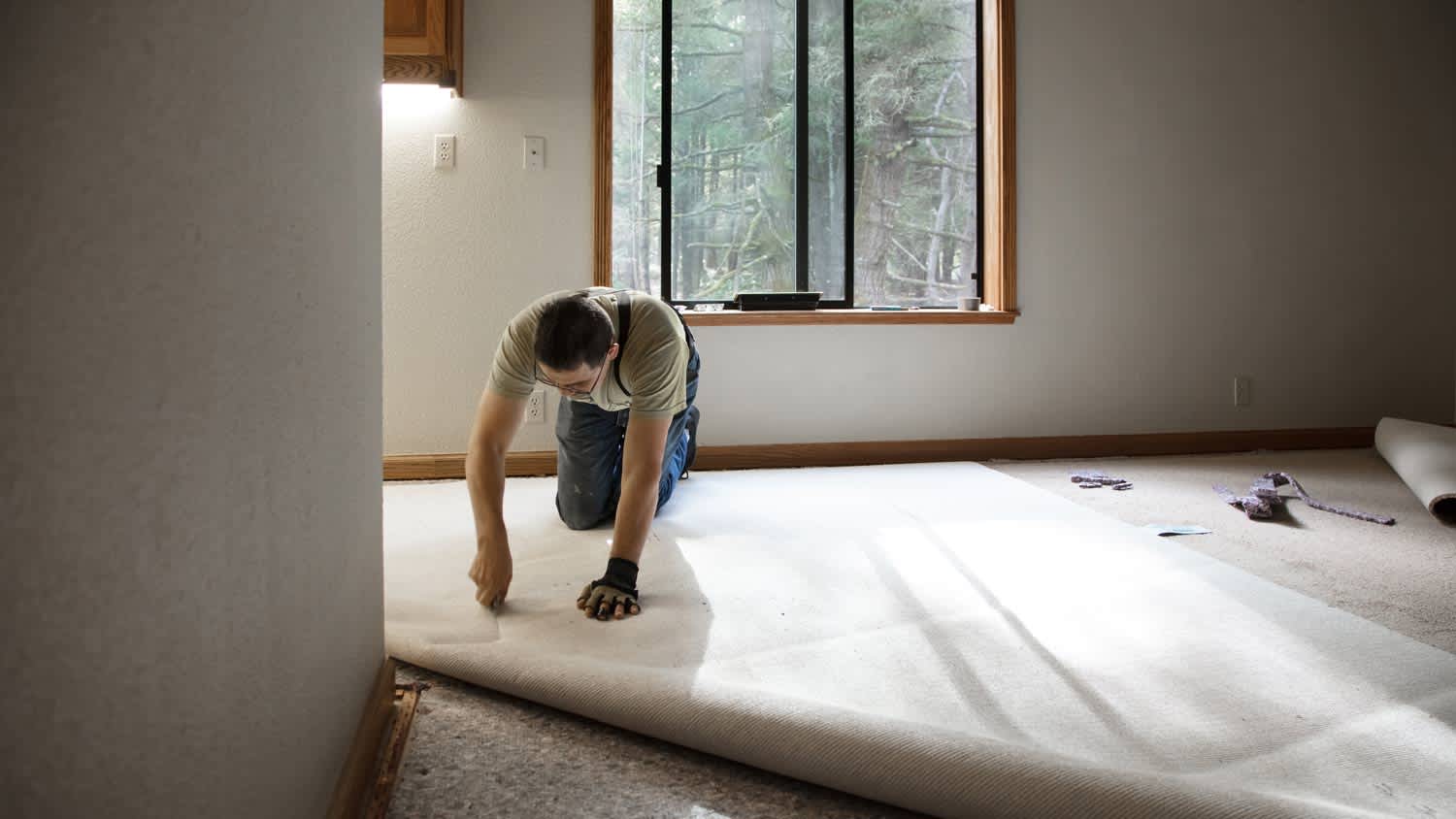 man installing carpet
