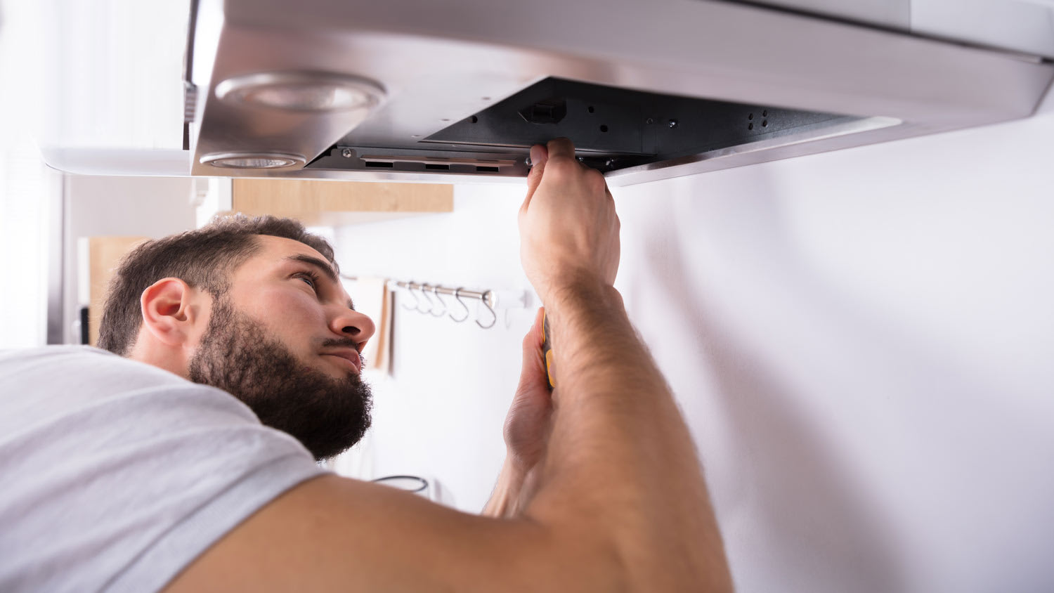man installing backdraft damper