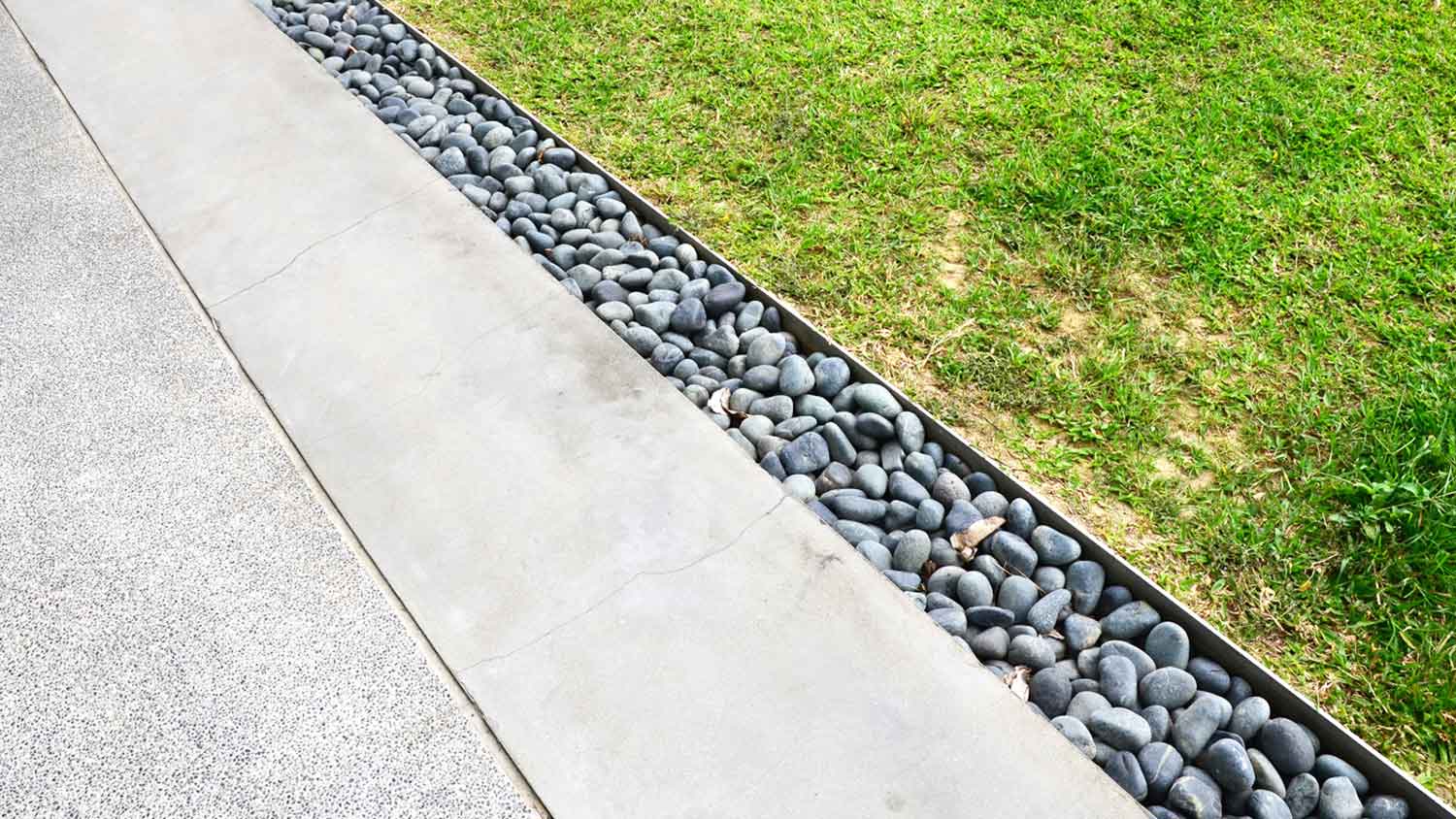 French drain installed along a concrete patio