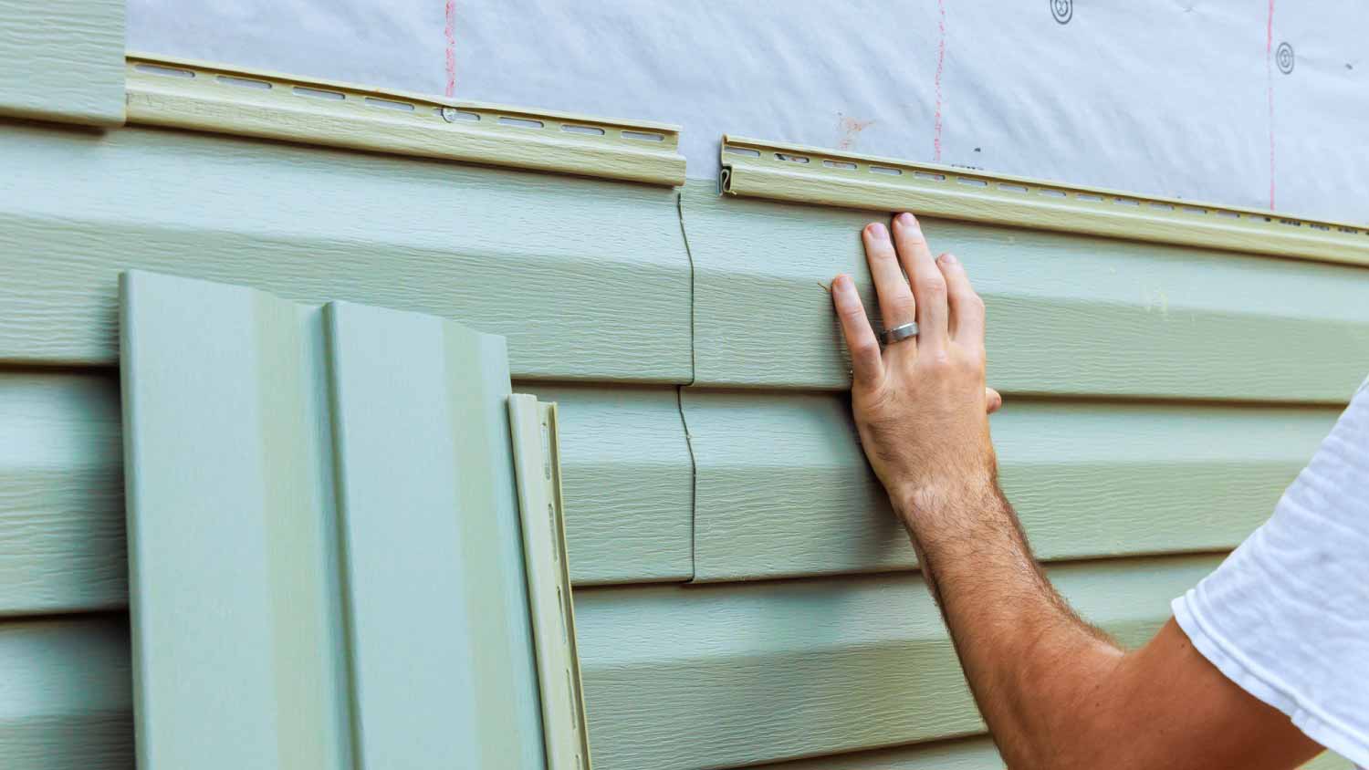 Man installing new exterior siding