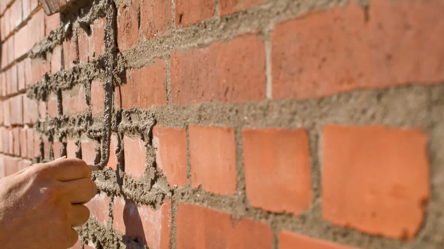 Bricklayer Repointing Old Bricks