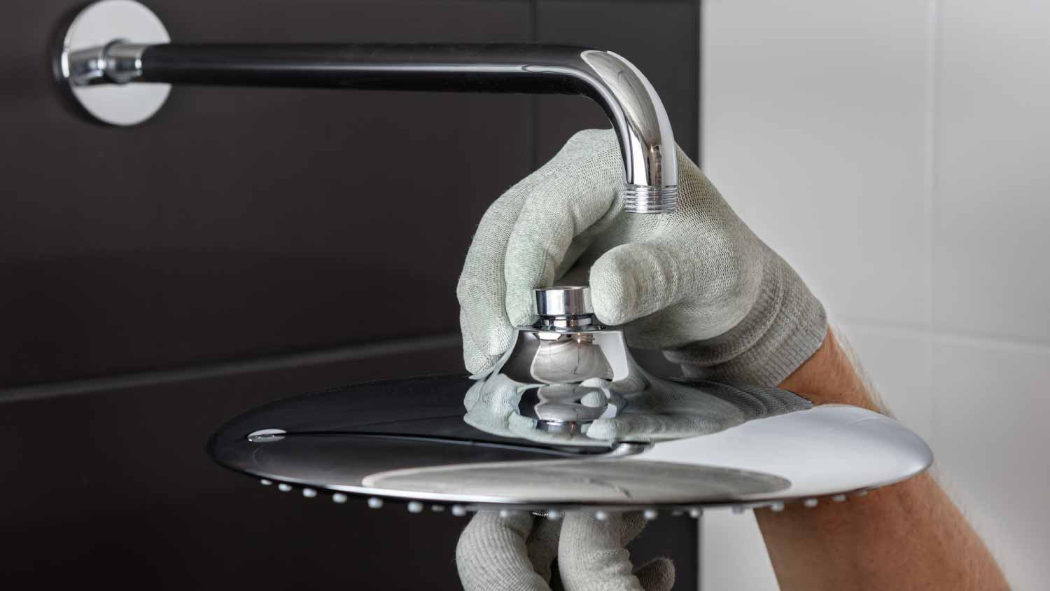 Worker installing shower head