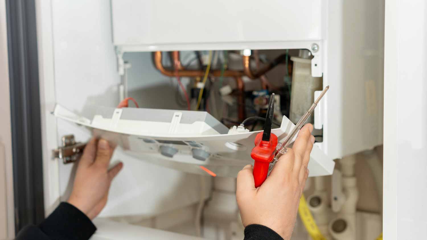 Technician repairing boiler