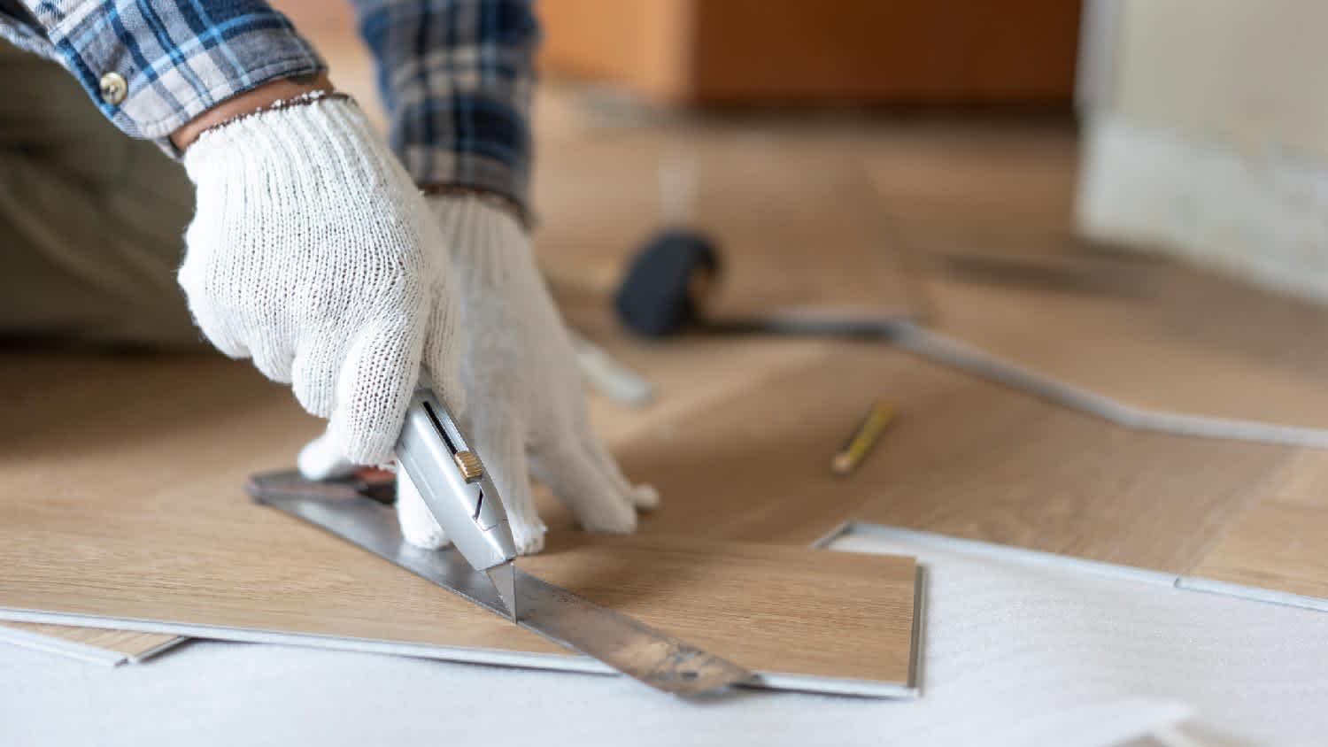 man laying down laminate floor