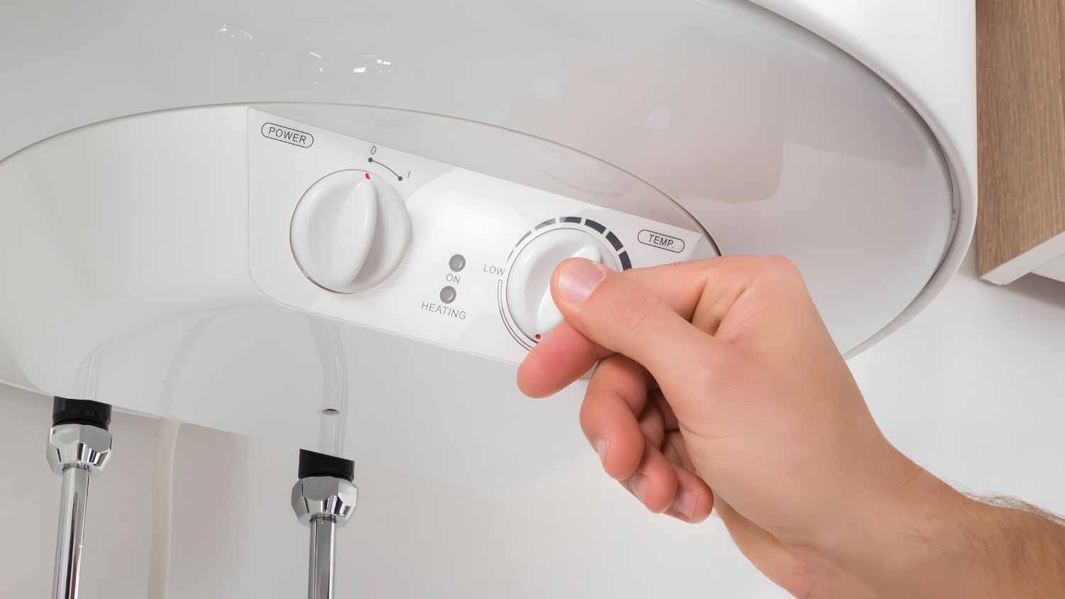 Worker adjusting temperature of water heater