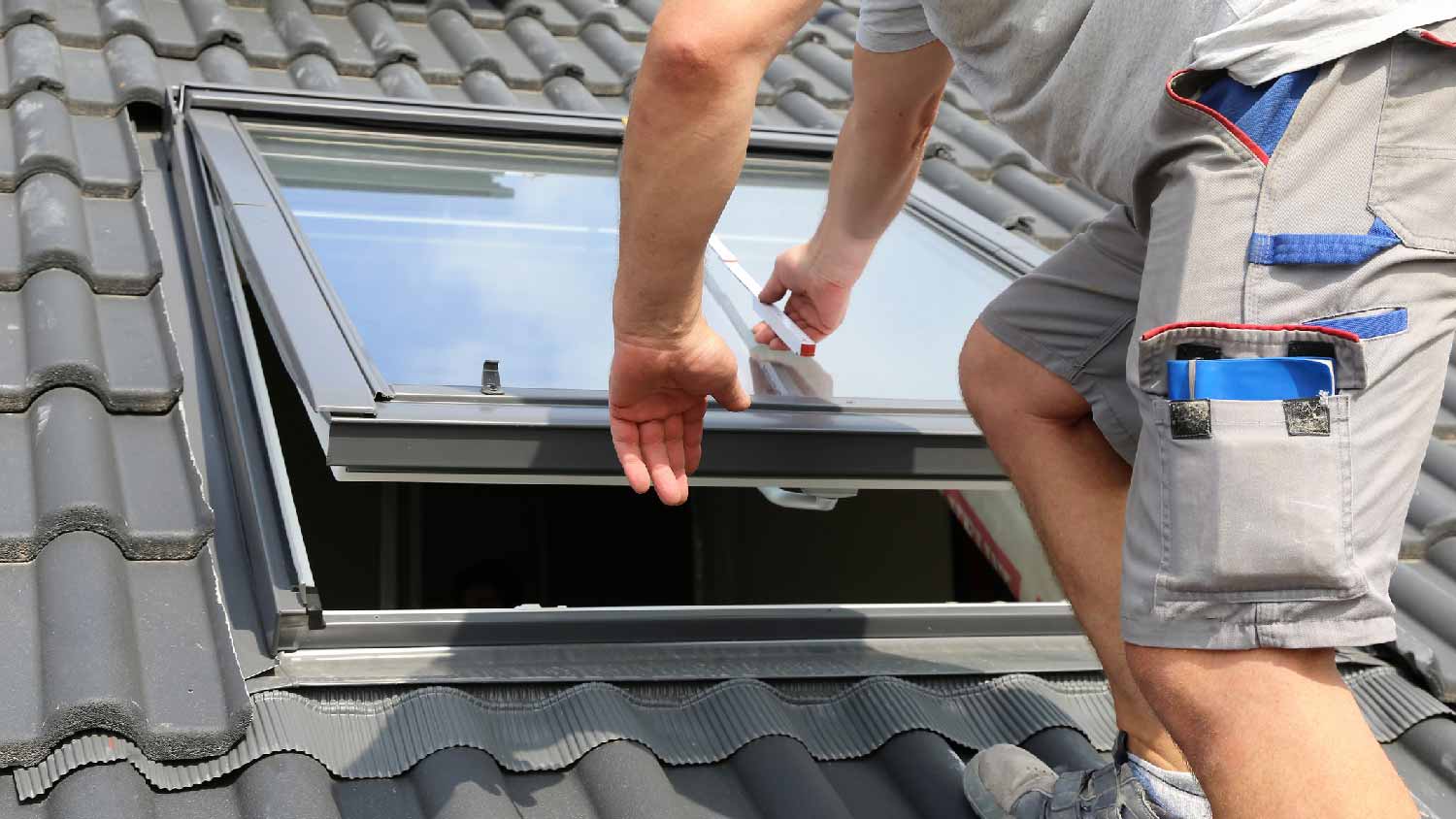 A builder installing a skylight