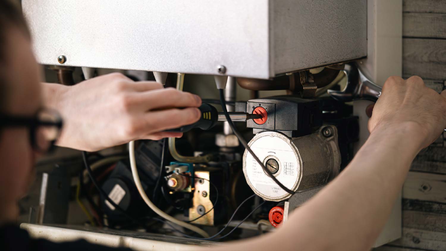 A person repairing a water heater