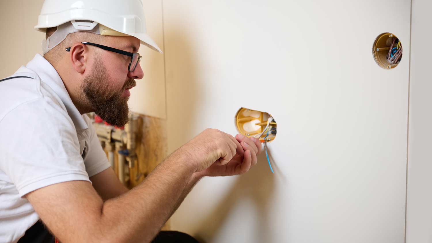 electrician installing electrical outlet