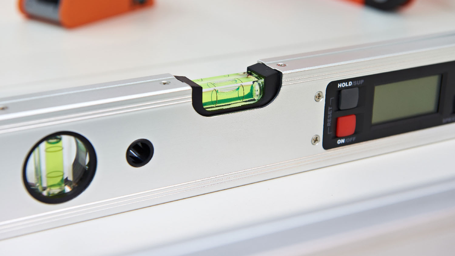 Close-up of a torpedo level on a washing machine