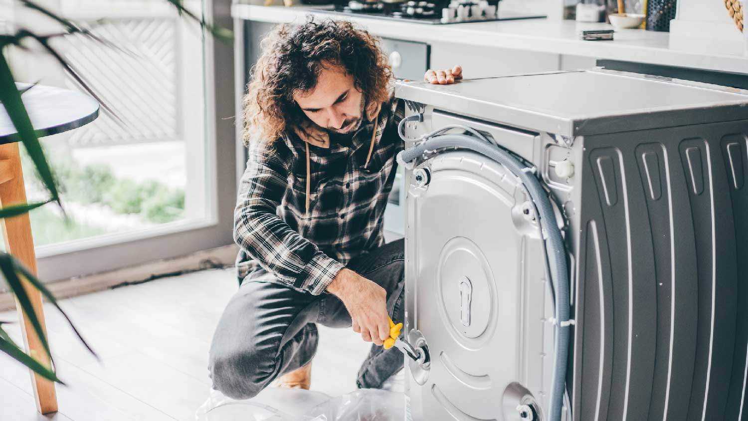 repairman working on washer machine
