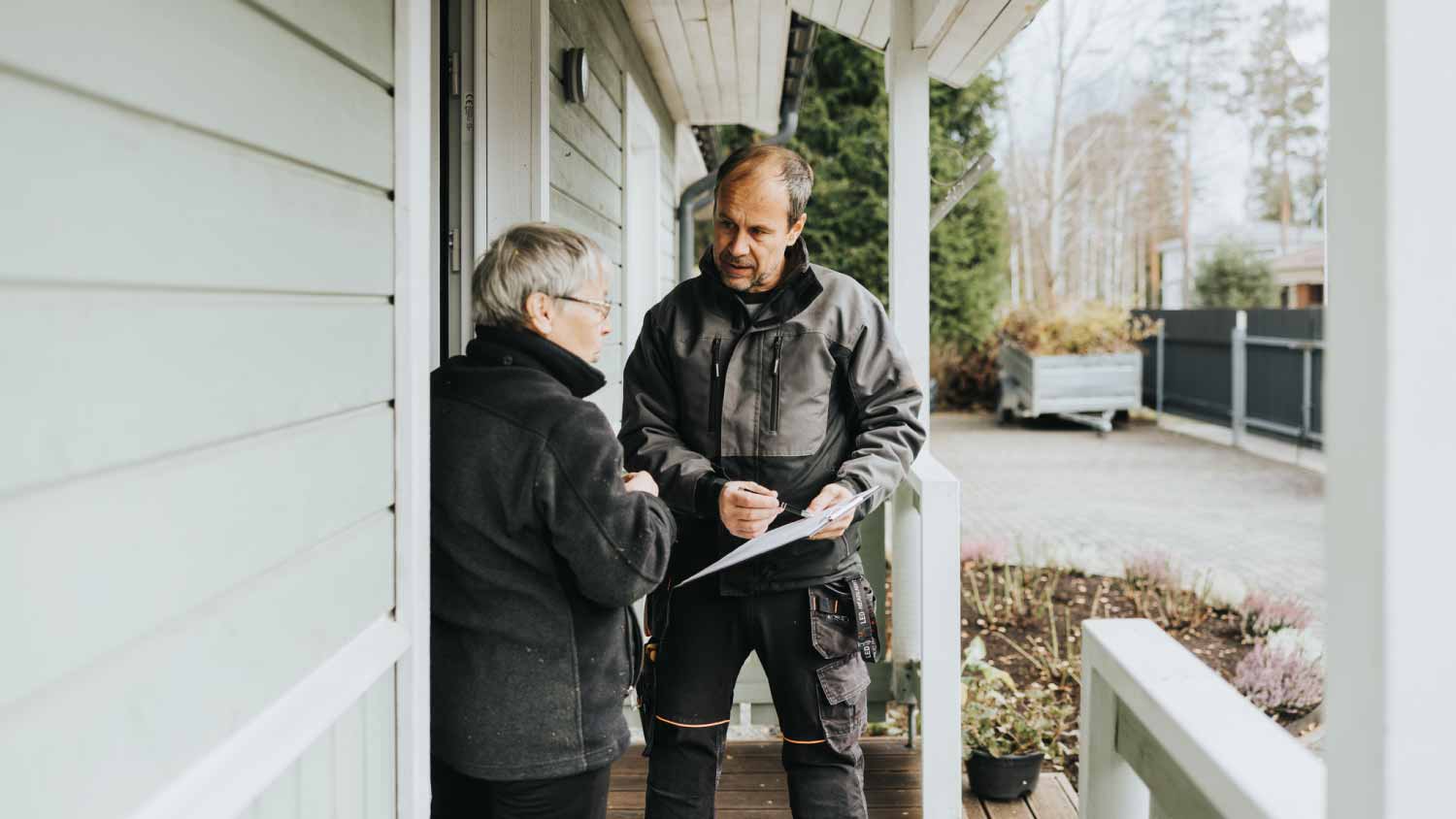 Plumber and customer signing invoice