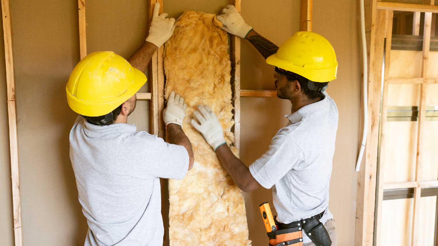 Two professionals insulating an attic