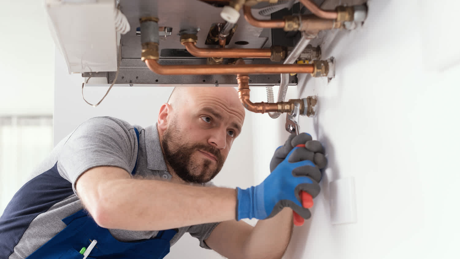 Professional engineer installing a boiler