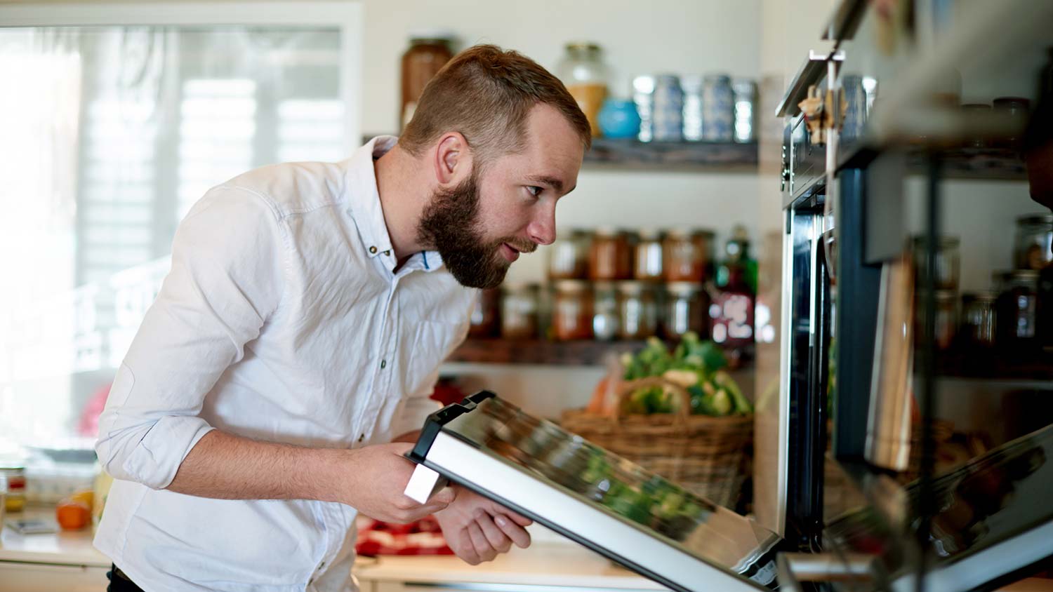 A man inspecting an oven
