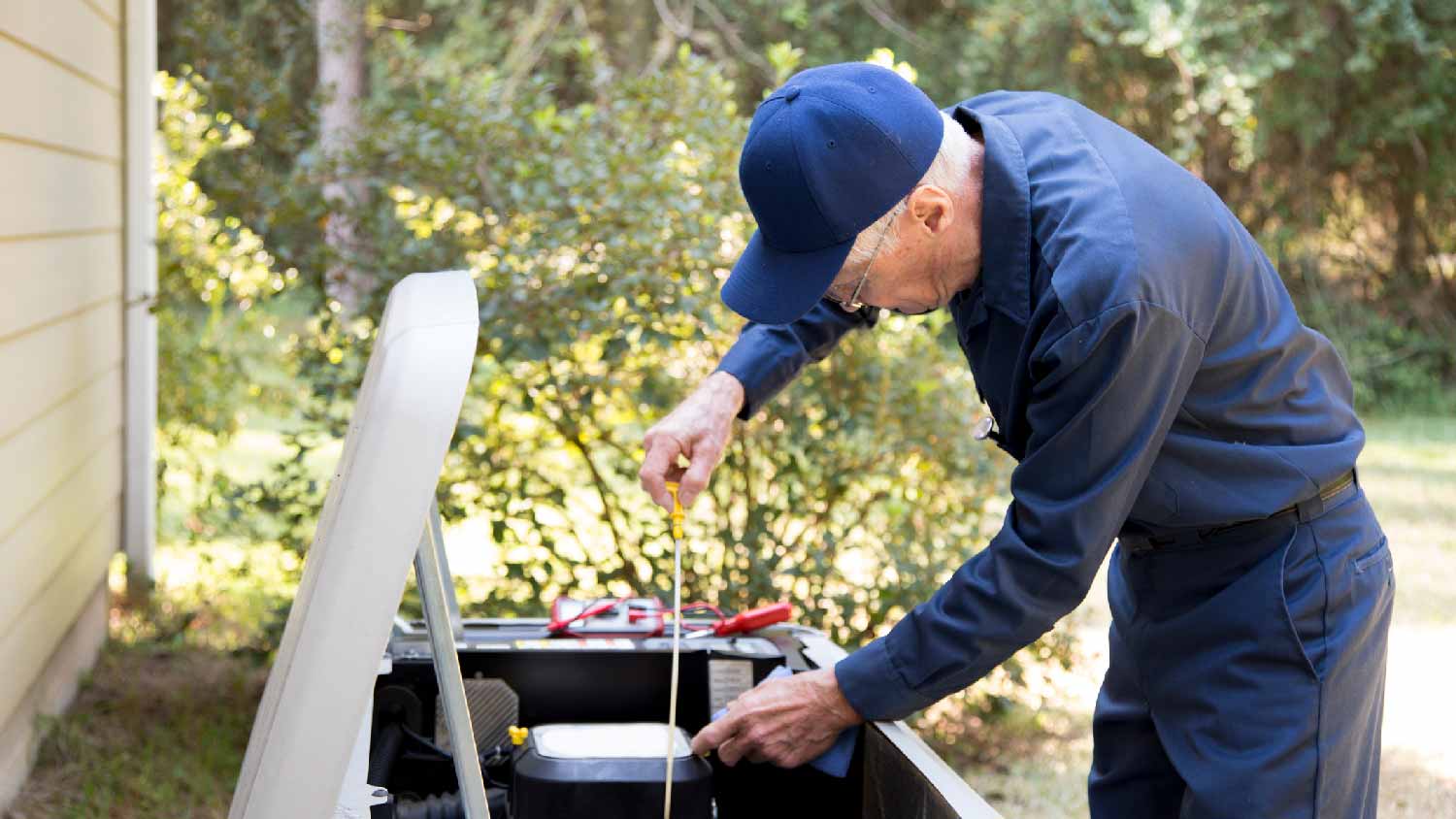 A professional repairing a house generator