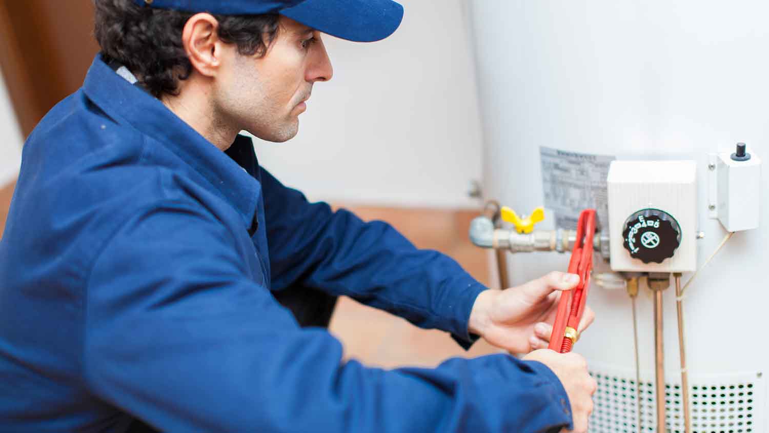 Professional connecting gas line to a new water heater