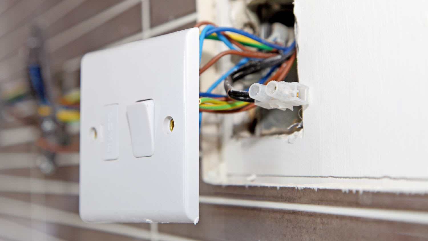 Close-up of a light switch and its wiring