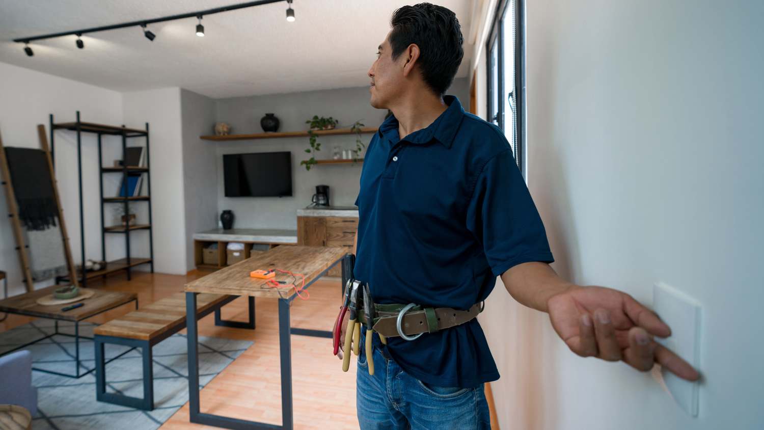 Electrician installing a dimmer to control the lights at a house