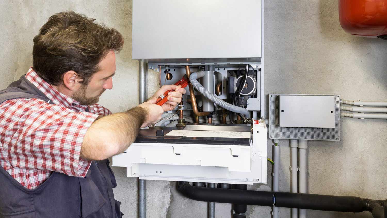 plumber repairing boiler