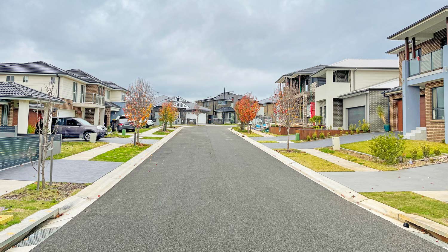 Houses along suburban street and overcast sky