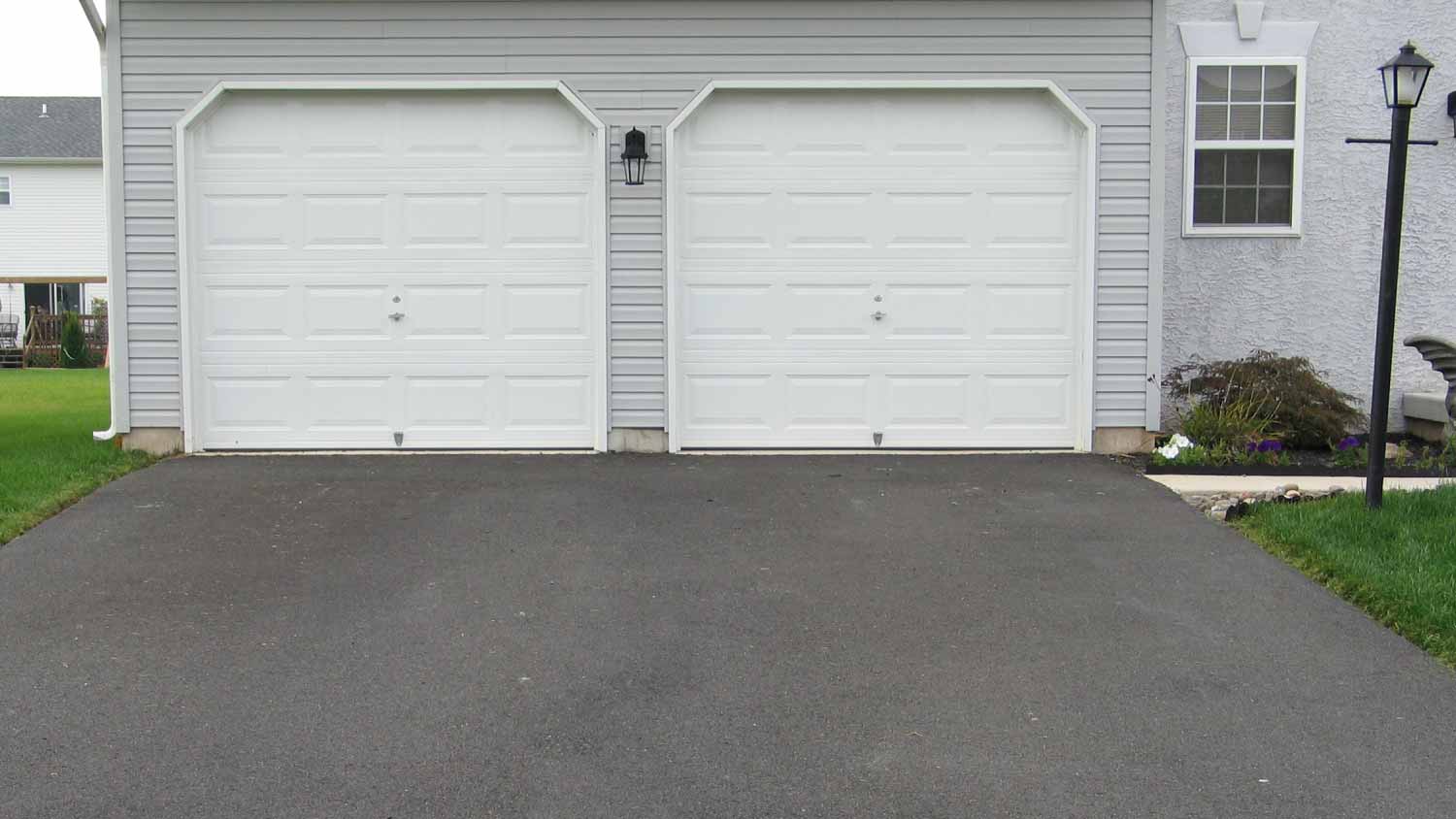 A double garage with white doors