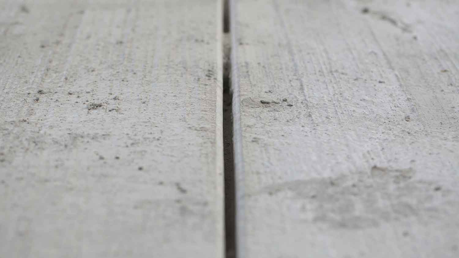 Closeup of expansion joint on a concrete driveway