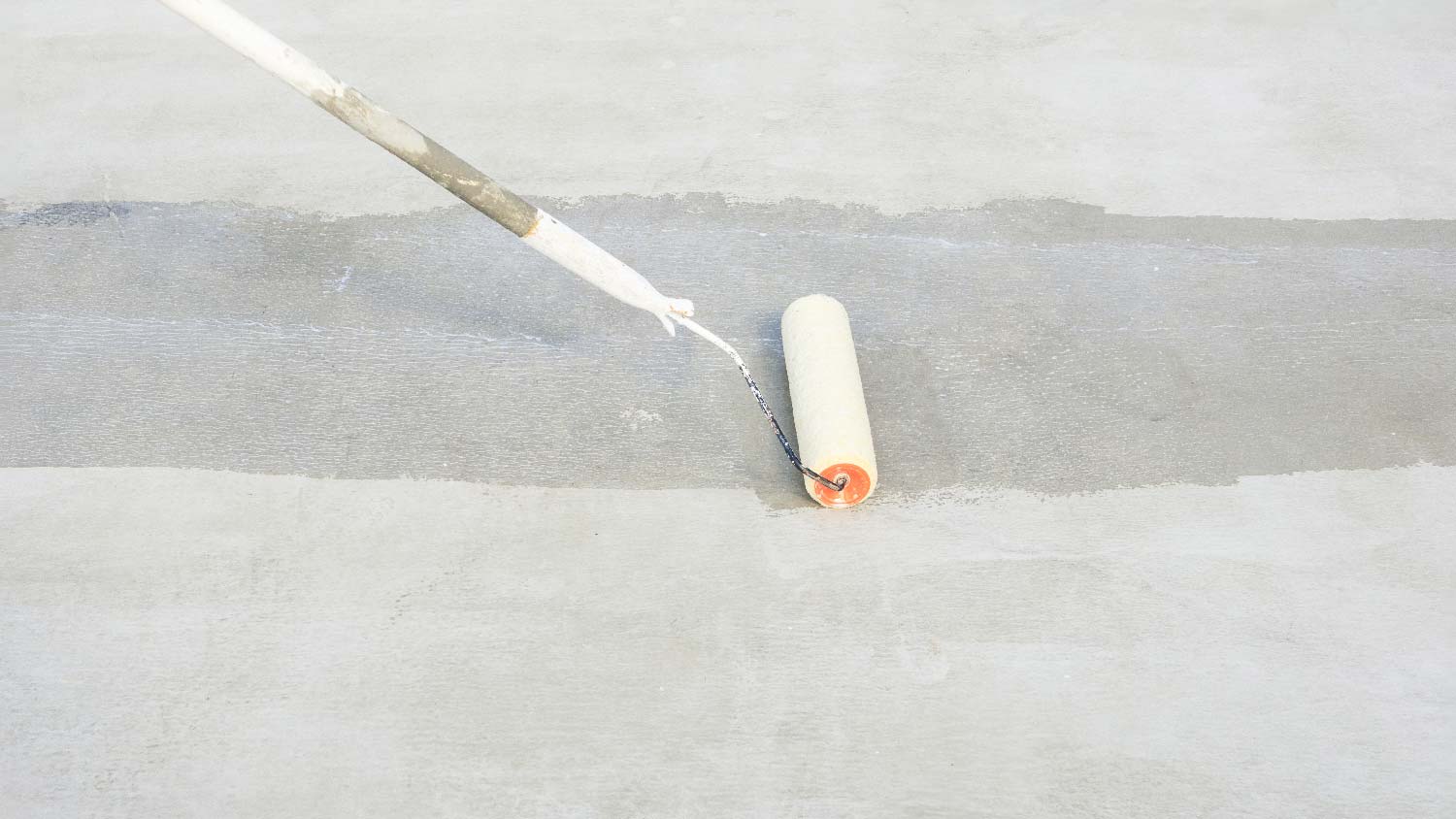 A person levelling a concrete patio
