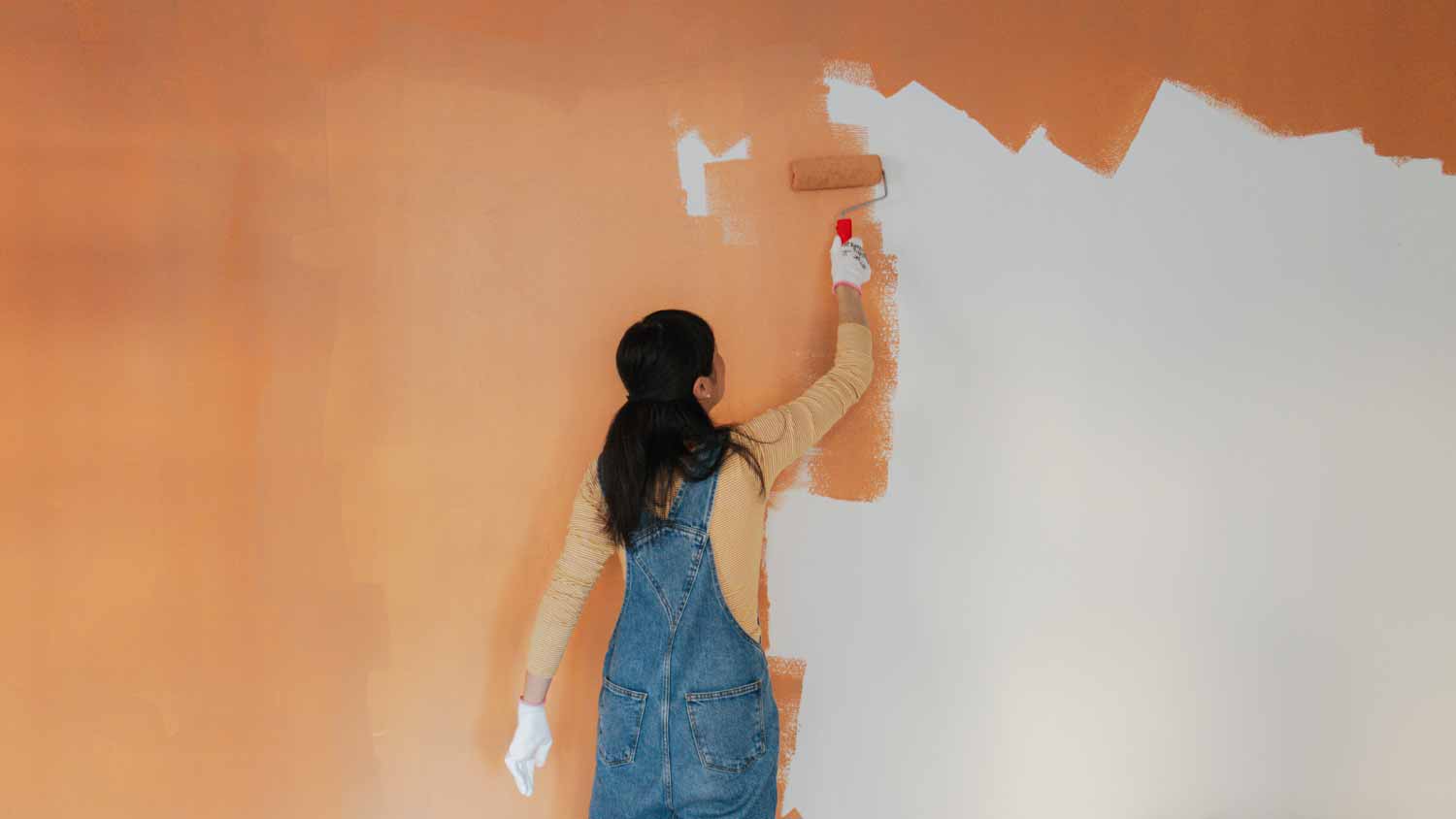 A woman painting walls