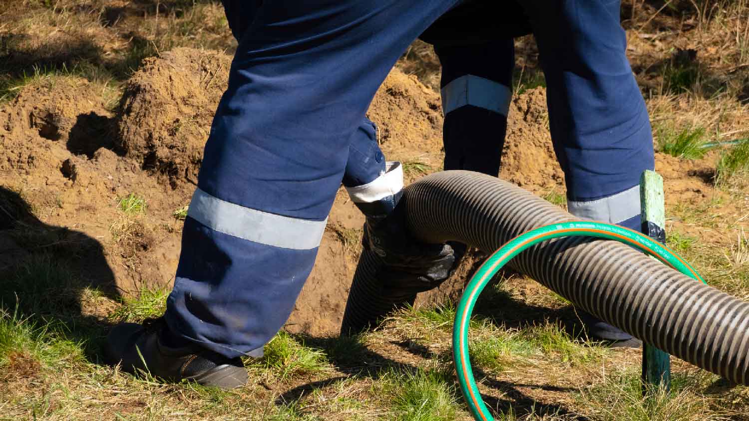 A professional cleaning a septic field line