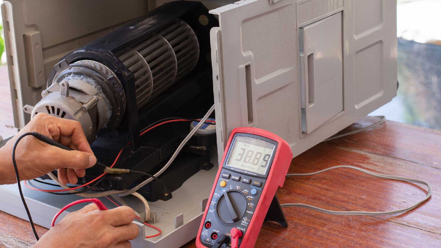 A person inspecting an HVAC unit