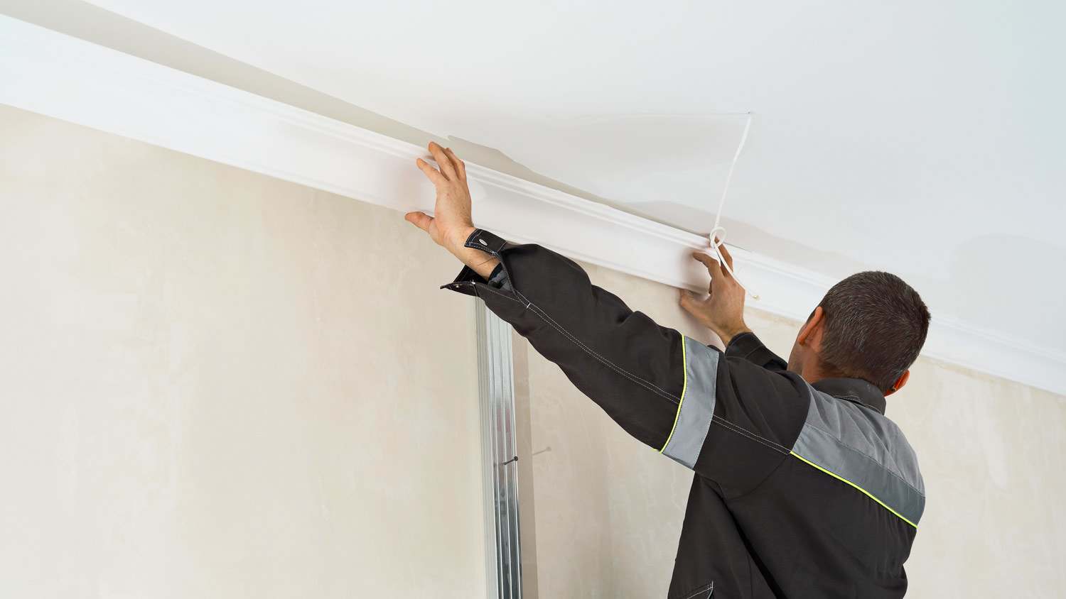 man installing crown molding