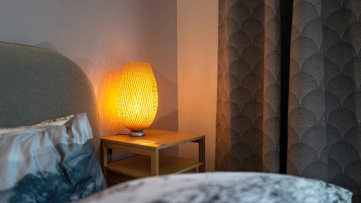 A bedroom lamp sitting on a nightstand