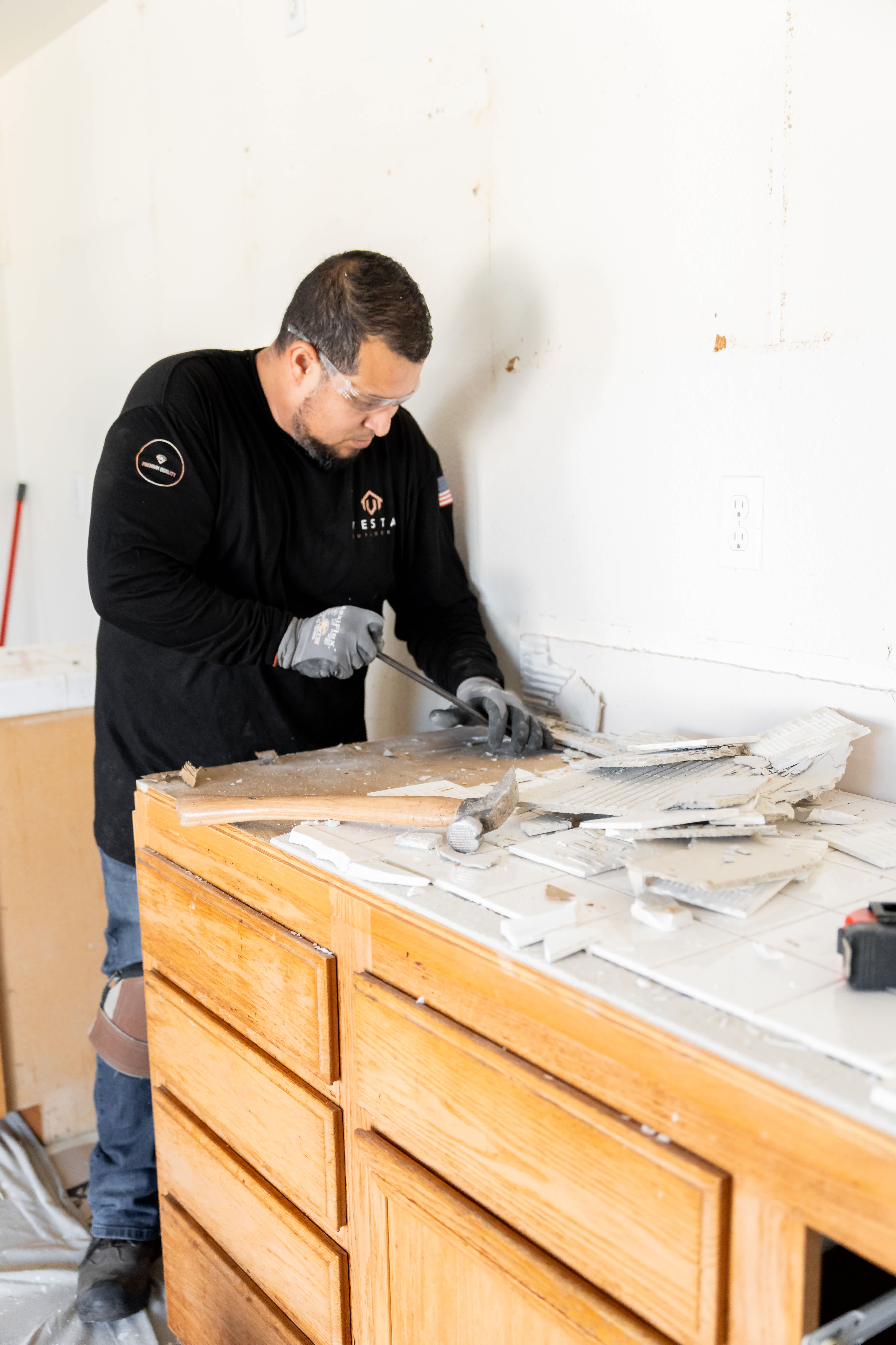 Person removing tile from a countertop