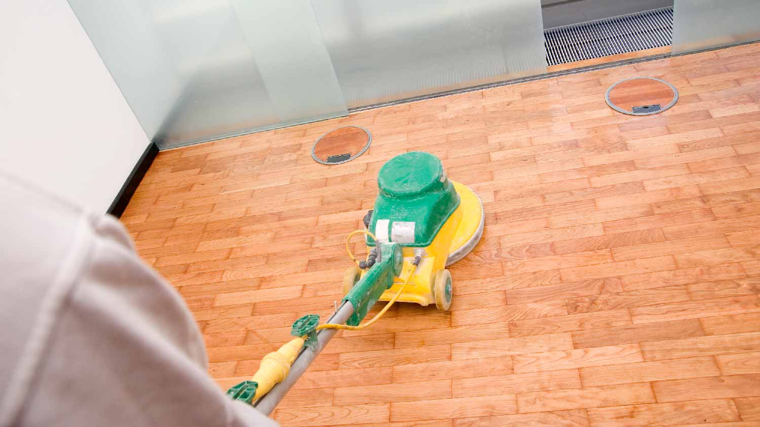 A person applying polyurethane with a squeegee