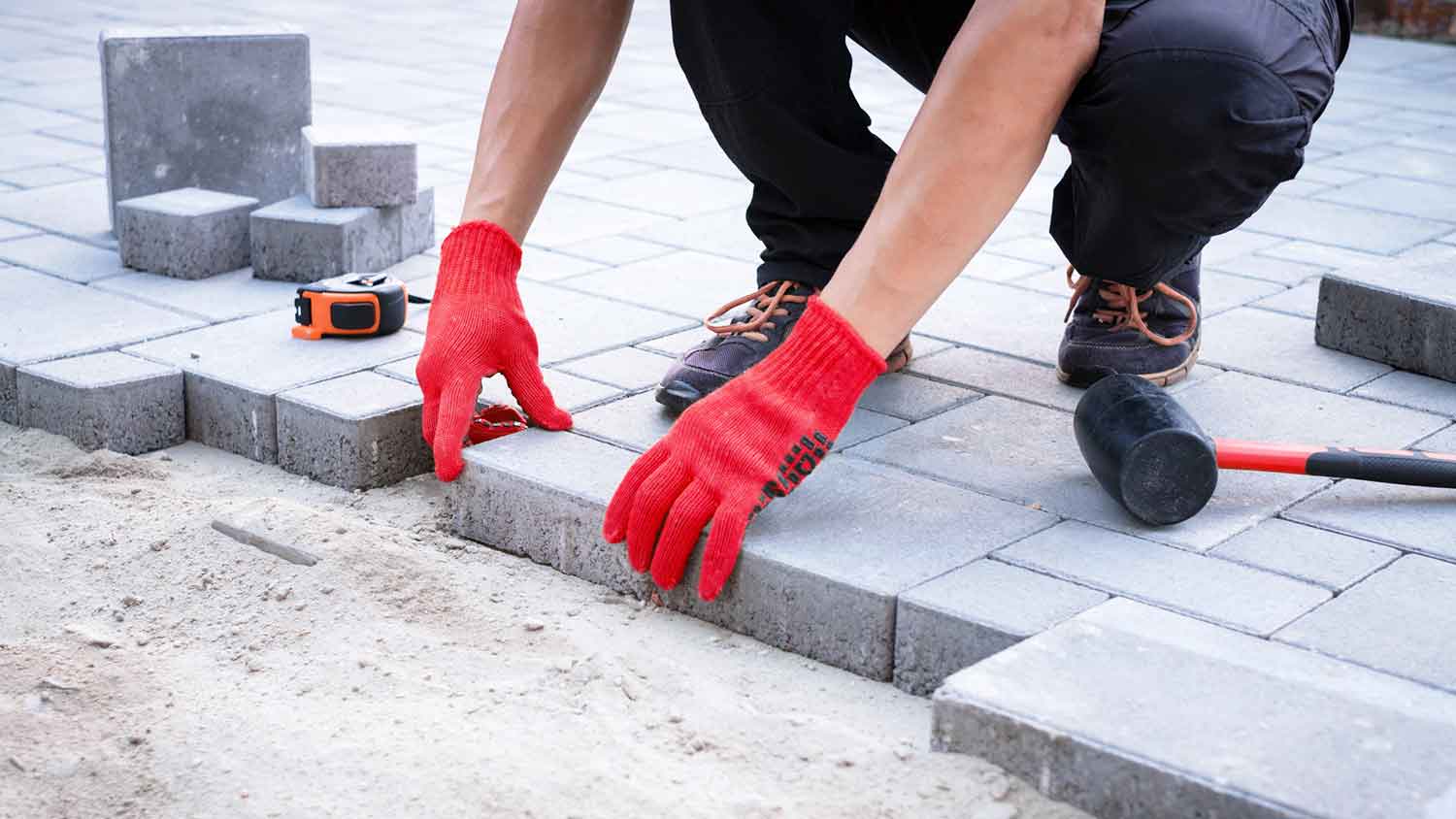 Contractor replacing stone pavers on the patio