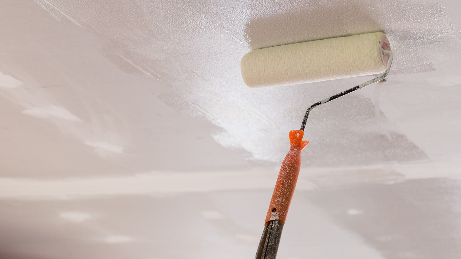 A paint roller on the ceiling